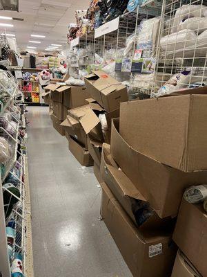 An entire aisle filled with boxes making it impossible to shop