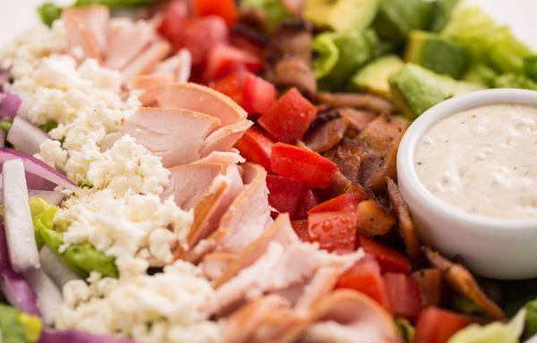 Chef Salad - Mixed greens, turkey, bacon, feta, tomatoes, avocado, and red onions.