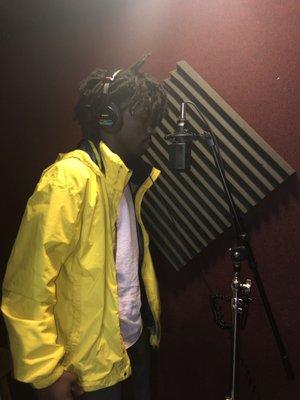 An artist recording in the vocal booth.