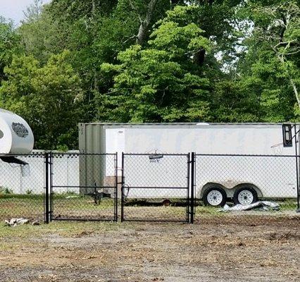 Black chain link fence with double drive gate, manual open