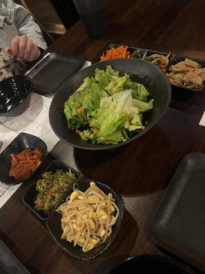 The banchan: spiced radish, sautéed veggies, fishcake, kimchi, baby anchovies, sautéed bean sprouts, and a salad