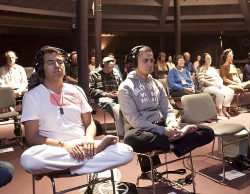 Xavier and J.J. meditating in the meditation hall at the Synchronicity Sanctuary.