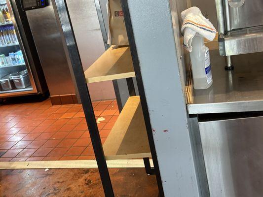 Bottle of cleaner and dirty rag left out at drink station. You can see how gross the floor looks, too.