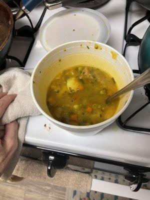 Unknown soup with peas, carrots, potatoes, herbs, and a little bit or chicken.