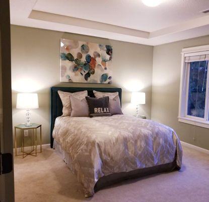 A relaxing Master Bedroom. Complimenting a green paint on the walls. Staged by Amethyst Interiors.