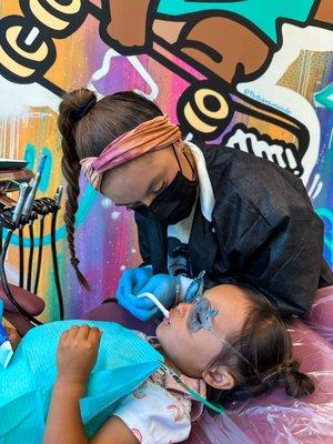 Dr. Jen helping make our little patient's first dental visit a success!