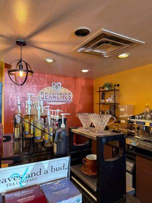 A view of the cafe service counter and selection of syrups