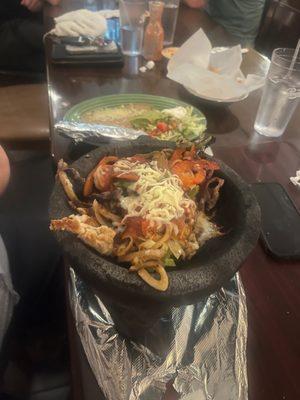 Molcajete - shrimp, beef, and chicken served with rice, beans and tortillas