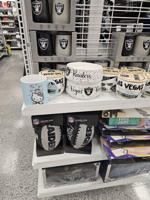 Hello Kitty mug along with Vegas Raiders gear