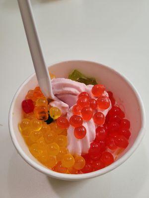 Strawberry lemonade and pomegranate yogurt with fruit, popping boba, and gummy bears!