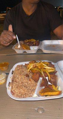 Griot with Rice comes with Pikliz , sauce and plantains