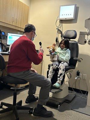 Dr Alan Levy giving Goldie an eye exam just like his patient