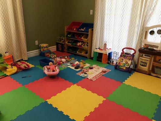 We have a large, safe, and fun play area inside with a variety of toys to play with.