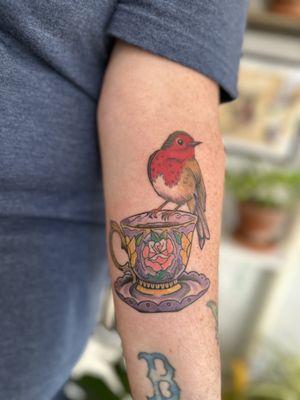 Red breast bird on a tea cup