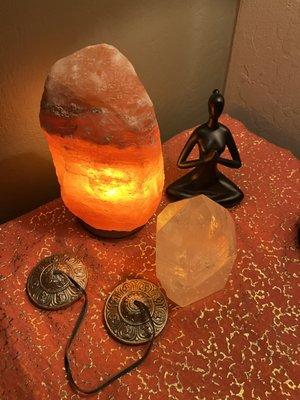 Salt lamp, tingsha bells and quartz crystal for energy amplification.