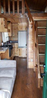 Interior of wooden "RV" sorta camper, more little house.