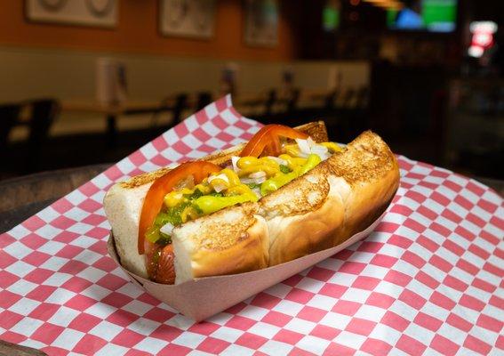 The Al Capone - All Beef Frank, Sport Peppers, Pickle, Onion, Tomato, Sweet Relish and Mustard Served on A Hawaiian Roll