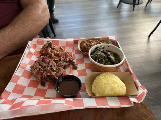 Pulled pork, mashed potatoes, baked beans, greens.