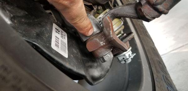 Gap in the assembly of the bolts holding the ball joint to the spindle.