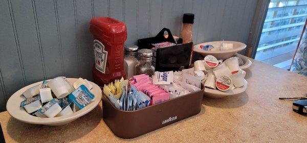 Tables are crowded. Everything is just sitting out on table. Used products in bowls also.