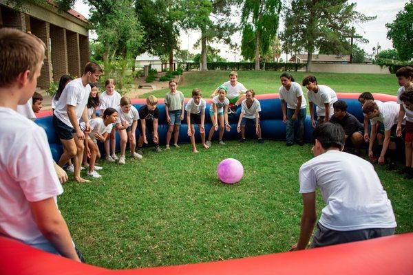 Grace Youth playing Gaga Ball outside on the lawn