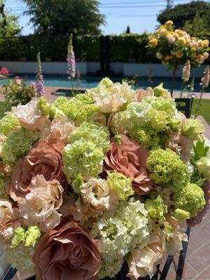 Arrangement with roses, viburnum, and lisianthus.