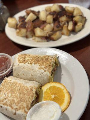 Scrambled egg wrap with cheddar cheese and bacon and a side of their amazing potatoes