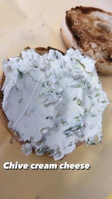 Scallion cream cheese on a toasted onion bagel