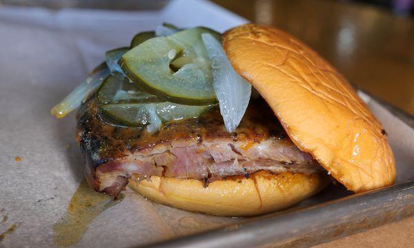 Pig Rib Sandwich. Columbus Original BBQ Sauce, Quarter Rack of Ribs, Bread and Butter Pickles, on top of a garlic butter grilled Potato Bun.