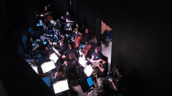 orchestra in sunken area in front of stage