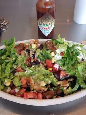 Burrito bowl: brown rice, half chicken half steak, mild salsa, corn salsa, sour cream, guacamole, lettuce. Chipotle Tabasco