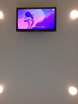 The ceiling-mounted TV playing "Sing" as I wait for Dr. Bailey.