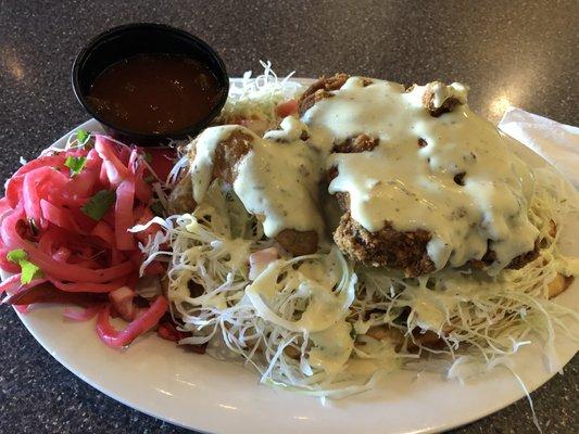 Fried Chicken over plantain with sauce. Yummy!