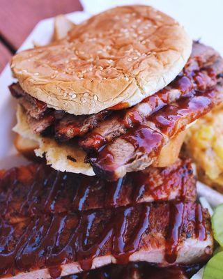 Sliced brisket sandwich, side of ribs and brisket Mac and cheese