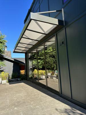 metal awning with translucent roofing to allow light to come through