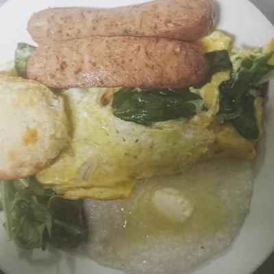 Feta and Spinach omelette, sausage, biscuit, and buttery grits