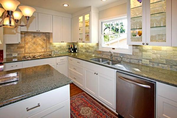 White painted cabinets with quartzite kitchen backsplash.