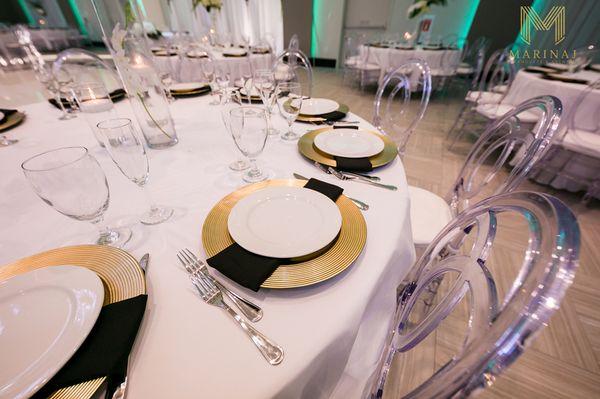 Tablescape Essentials! Luxe gold chargers and black linen napkins are one of our many table setting options