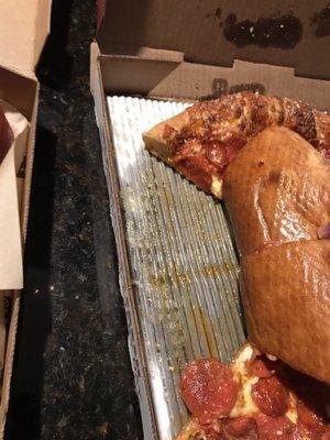 This oil soaked pizza folded over like a wet napkin. All this grease under the pizzas was an unwelcome surprise.