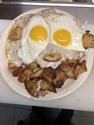 Biscuits covered with sausage gravy and to Sunnyside egg and our homemade home fries