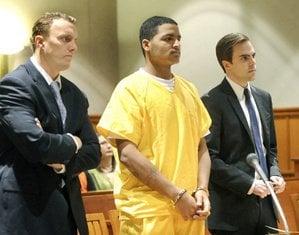 Flanked by attorneys Peter Cyr and Dylan Boyd, Anthony Pratt makes his initial court appearance on April 26, 2013.