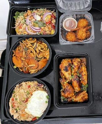 Pineapple fried rice, coconut shrimp, chicken stir-fry with vegetables, rice with pork, and chicken wings.