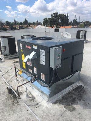 A brand new Goodman rooftop package unit complete with adapter curb.