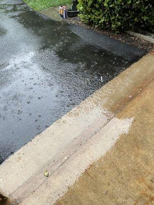 This is a photo of water trapped on the concrete skirt because the asphalt is too high.