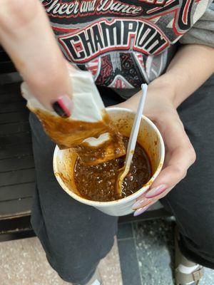 My daughter using a napkin to soak up grease from the chili