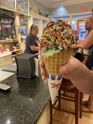 Mint chocolate chip & cookies n cream in a waffle cone w/ rainbow sprinkles