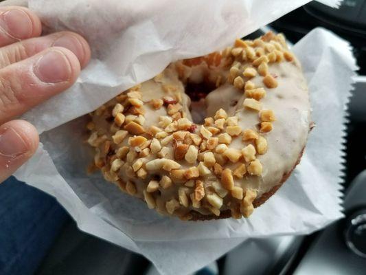 Cake donut with maple frosting and peanuts