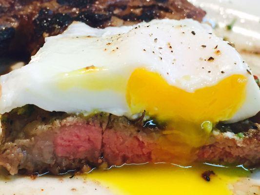 Medium rare Rib Eye with poached egg on top. Ate the steam veggies and salad already. Cutting the egg and steak together surprised me.