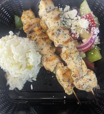 Chicken souvlaki with rice and a Greek salad