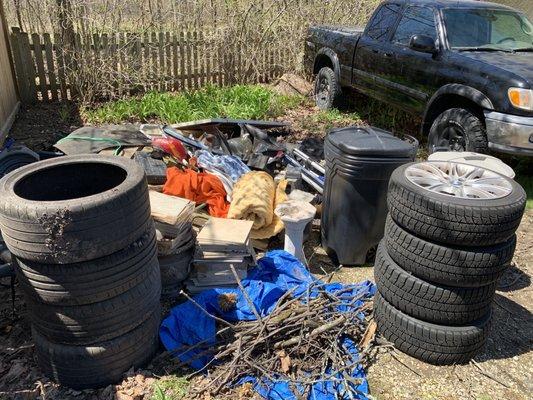 Another angle of "before" showing two sets of tires, two full garbage cans, yard debris and other accumulated junk from our garage and shed.